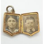 Victorian yellow metal locket and photos, weight 9.8g and 2x3cm size