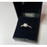 9ct white gold ring having 0.50ct Zirconia solitaire in four claw mount to top with Zirconia flashes