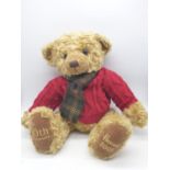 Harrods 20th anniversary Teddy bear with a red knitted jumper and tartan scarf. Approx. 50cm tall.