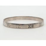 Tiffany silver and diamond bangle with Roman numerals, weight 21.6g and 63mm width.