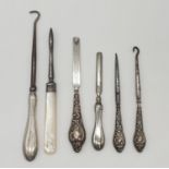 A selection of late 19th/early 20th century silver handled manicure and buttoning items, all with