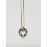 A 9ct heart shaped pendant with blue and white stone on a 42cm long 9ct gold chain, weight 2.1g