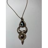 Silver and onyx pendant in retro Victorian Gothic style and having a silver chain of 45cm long,
