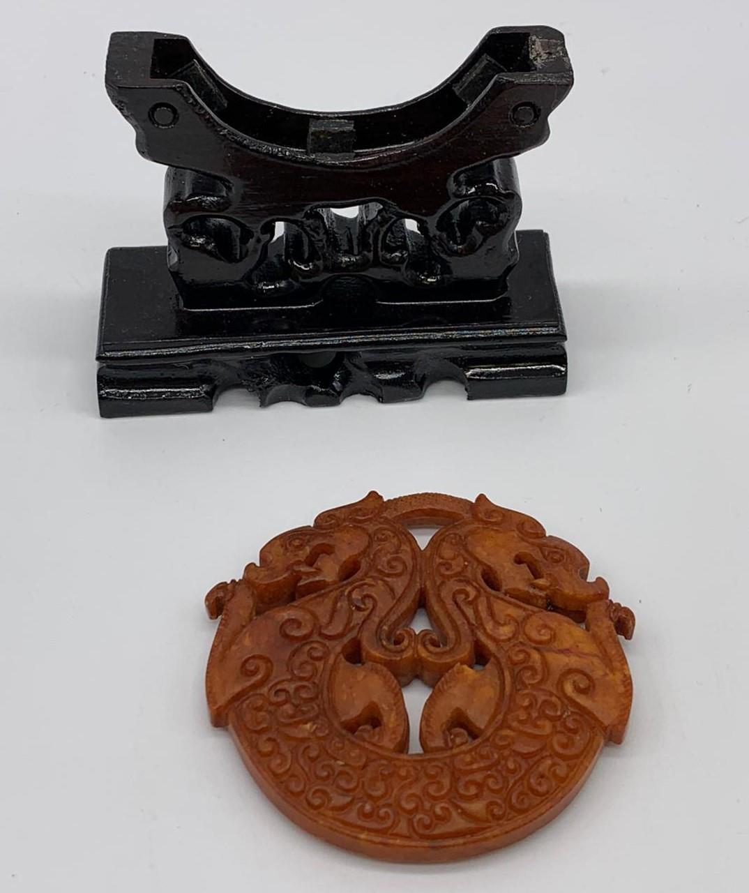 A Chinese, hand carved on both sides and pierced, orange hard stone amulet representing two - Image 3 of 4
