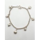 Silver charm bracelet with 7 charms, weight 7.68g and 18cm long approx
