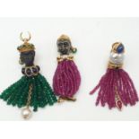 An unusual brooch and earring set, set in 18ct gold and having emerald, sapphire, ruby and