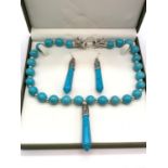 A Tibetan turquoise style necklace and earrings set in a presentation box. Necklace clasp in the