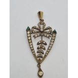 A yellow metal Victorian pendant with white stone decoration. 5.5g, 6cm in length.