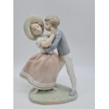 Lladro boy kissing girl handmade in Spain. 27cm tall.