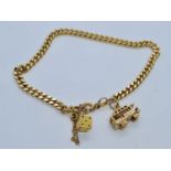 9ct gold bracelet with two charms weight 12.5gm, 18cm in length.
