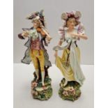 Two tall ceramic figures of violin player and lady. Slight damage to to violin players hand.