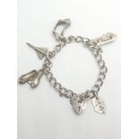Silver charm bracelet with 6 charms and heart padlock, weight 28.5g a and 16cm long approx