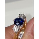 18K YELLOW AND WHITE GOLD WITH BLUE SAPPHIRE CENTRE (6.3MM) AND TWO DIAMONDS ON THE SIDES (0.35CT