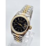 ROLEX Oyster Perpetual Datejust ladies watch with black face and two tone steel strap, 22mm case