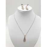 Silver jewellery set to include pendant on chain and matching pair of earrings. Mother of pearl