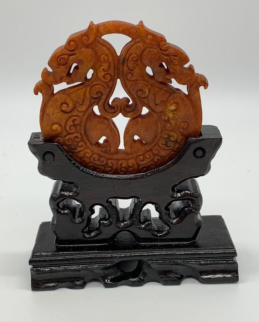 A Chinese, hand carved on both sides and pierced, orange hard stone amulet representing two - Image 4 of 4