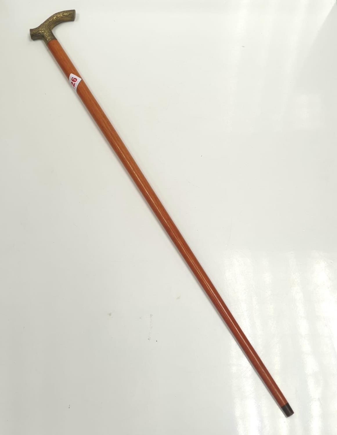 One light mahogany gentleman's walking stick with floral design on antler shaped metal handle.