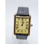 Must De Cartier vintage gents watch with black leather strap, manual winding 22mm x 25mm case.