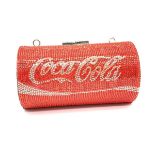 A funky, evening bag designed in the style of a COCA COLA tin, totally covered with Swarovski