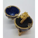 A yellow metal (untested) Chinese dragon ring presented in Faberge style egg.