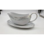 Crown Ming fine China gravy boat and accompanying oval plate, with blue floral design edging by Jian