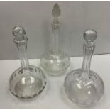 Set of three glass decanters one with Victorian style floral design, diamond cut stoppers. Width