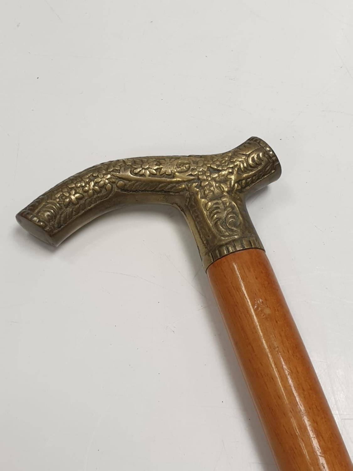 One light mahogany gentleman's walking stick with floral design on antler shaped metal handle. - Image 3 of 4