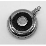 A small metal water hip bottle that attaches to a belt. 12cms in diameter.