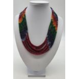 A statement 7 row necklace with rubies, emeralds, sapphires and other precious stones of high