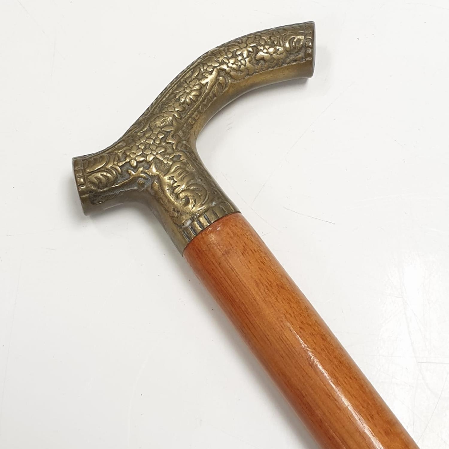 One light mahogany gentleman's walking stick with floral design on antler shaped metal handle. - Image 2 of 4