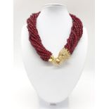 A 15 row statement necklace with faceted rubies and a large Cartier Panther style clasp. Rubies
