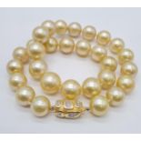 Golden graduated south sea pearl set in 18ct yellow gold and diamond clasp, individually knotted