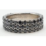 A black Moissanite diamond band ring in sterling silver. Weight 7.80g, Size X.