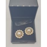 Pair of silver earrings having faux pearl centre stones with seed pearl surround. Silver gilt.A/F.