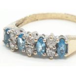 9ct Gold ring having aquamarine and clear stones set to top in half hoop style. Size O. 2.4 grams