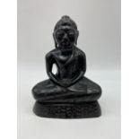 Carved wooden cross legged (in Lotus position). Figure of a Buddhist god. 18cm tall.