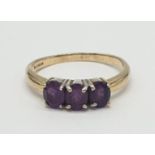 9ct gold ring having a dark amethyst trilogy to top, boxed full UK hallmark for Birmingham 9ct gold,