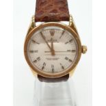 Vintage 18ct Rolex oyster perpetual gents watch with gold case and leather strap, automatic and 36mm