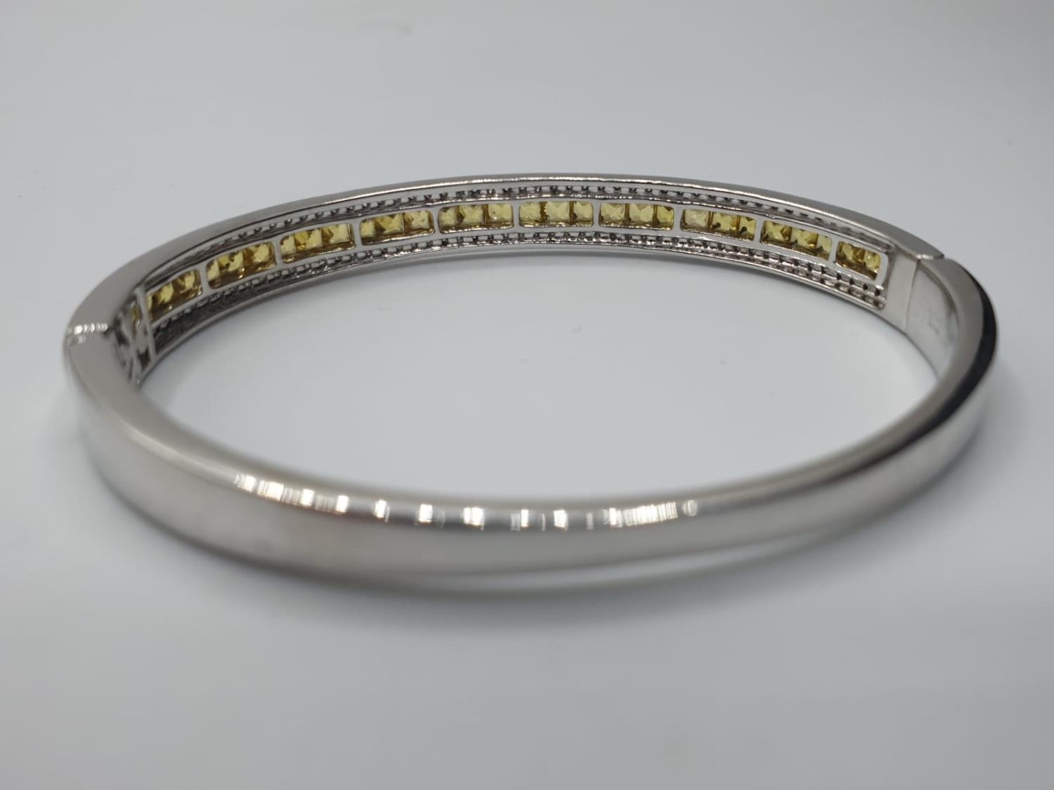 18ct White Gold Hinged Bangle with Channel Set Diamond ( 0.90ct) and Yellow Sapphire Designed by - Image 2 of 5
