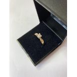 9ct gold and diamond ring having an 0.12ct single stone in a square mount to top, full UK hallmark
