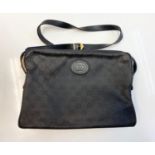 Vintage Gucci styled black canvas messenger bag. 2 side compartments with interior zipped pocket.