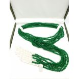 An interesting and versatile, three very long rows of green jade and pearls, necklace. It can be