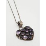 Silver and amethyst heart shaped pendant mounted on silver chain, pendant full of amethysts of
