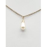 Pearl pendant on a 50cm 9ct gold chain. Weight 3g.