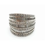 Stone set silver ring having seven rows of zirconia's in round and baguette form. Clear hallmark for