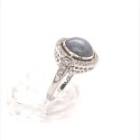 18ct white gold ring with 5ct round miligrain halo star sapphire unheated centre stone, and 0.25ct