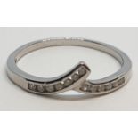 9ct White gold diamond set twist band ring. Weight 1.2g Approx. 0.10ct of diamond, Size M.