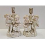 Pair of ceramic candlesticks with figures in Victorian themed fashion. Height 19cm.