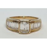 Yellow gold ring with baguette cut diamonds, centre stone 0.85ct and further 0.50ct diamonds on each