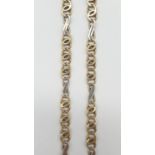 An interlink necklace in white and yellow gold gold, weight 21.2g and 48cm long approx